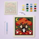 Toile imprimée numérotée posée près du tableau punch needle arbre habité terminé