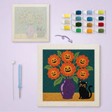 Toile imprimée numérotée à côté du tableau punch needle bouquet et chat noir terminé