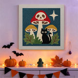 Tableau punch needle champignon crâne accroché au mur dans un décor d'Halloween