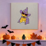 Tableau punch needle chat à lunettes accroché au mur dans une déco d'Halloween