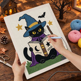 Broderie punch needle en cours sur la toile du chat qui lit son livre, aiguille en main