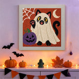 Tableau punch needle chat fantôme accroché au mur dans une déco d'Halloween
