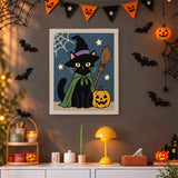 Tableau punch needle chat à la citrouille accroché au mur dans une déco d'Halloween