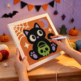 Broderie punch needle en cours sur la toile du chaton et de son seau crâne