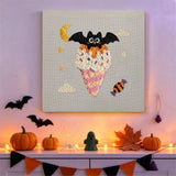 Tableau punch needle cornet rose et chauve-souris accroché au mur dans une déco d'Halloween