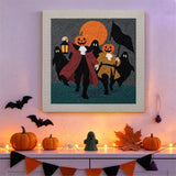 Tableau punch needle cortège de citrouilles accroché au mur dans une déco d'Halloween