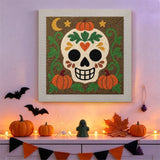 Tableau punch needle crâne en sucre accroché au mur parmi des décorations d'Halloween