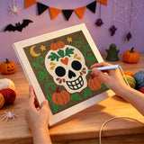 Broderie punch needle en cours sur la toile du crâne aux citrouilles