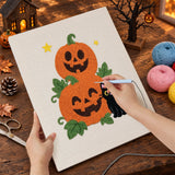 Broderie punch needle en cours, aiguille en main, sur la toile des deux citrouilles
