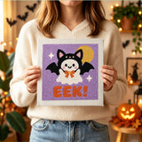 Tableau punch needle fantôme en chauve-souris tenu en main pour montrer sa taille