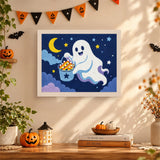 Tableau punch needle fantôme et son seau de bonbons accroché au mur dans une déco d'Halloween