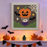 Tableau punch needle montgolfière citrouille accroché au mur dans une déco d'Halloween
