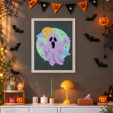 Tableau punch needle fantôme lilas aux bras levés accroché au mur dans une déco d'Halloween