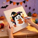 Broderie punch needle en cours, aiguille en main, sur la toile du fantôme sorcière et sa citrouille
