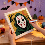 Broderie punch needle en cours sur la toile du masque blanc aux traits rouges
