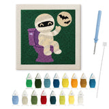 Contenu du kit punch needle momie aux WC : toile sur cadre, aiguilles et fils de laine