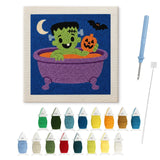 Contenu du kit punch needle monstre au bain : toile sur cadre, aiguilles et fils de laine