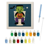 Contenu du kit punch needle monstre aux WC : toile sur cadre, aiguilles et fils de laine
