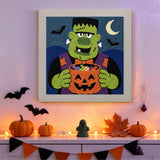 Tableau punch needle monstre aux bonbons accroché au mur dans une déco d'Halloween