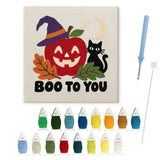 Contenu du kit punch needle pomme Halloween : toile sur cadre, aiguilles et fils de laine