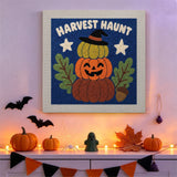 Tableau punch needle potirons empilés accroché au mur dans une déco d'Halloween