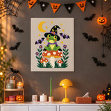 Tableau punch needle grenouille au chapeau pointu accroché au mur dans une déco d'Halloween