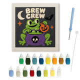 Contenu du kit punch needle grenouille potion : toile sur cadre, aiguilles et fils de laine