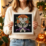 Tableau punch needle roses squelette tenu en main pour montrer sa taille