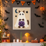 Tableau punch needle chat siamois fantôme accroché au mur dans une déco d'Halloween