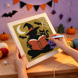 Broderie punch needle en cours sur la toile de la sorcière au livre et de son chat