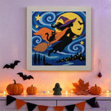 Tableau punch needle silhouette de sorcière accroché au mur dans une déco d'Halloween