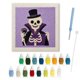 Contenu du kit punch needle Halloween squelette comte : toile sur cadre, aiguilles et fils de laine