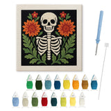 Contenu du kit punch needle squelette fleuri : toile sur cadre, aiguilles et fils de laine