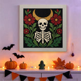 Tableau punch needle squelette sous la lune accroché au mur dans une déco d'Halloween