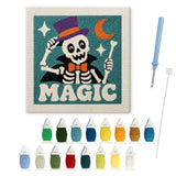 Contenu du kit punch needle squelette magie : toile sur cadre, aiguilles et fils de laine