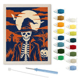 Contenu du kit punch needle squelette rétro : toile sur cadre, aiguilles et fils de laine