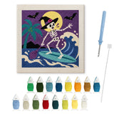 Contenu du kit punch needle squelette surfeur : toile sur cadre, aiguilles et fils de laine