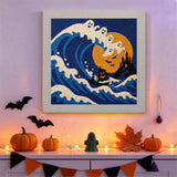 Tableau punch needle vague aux fantômes accroché au mur dans une déco d'Halloween