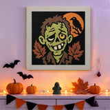 Tableau punch needle zombie et corbeau accroché au mur dans une déco d'Halloween